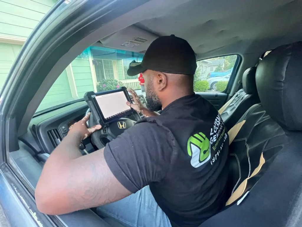 locksmith technician inside vehicle reprogramming the car lock system for a resident in portland